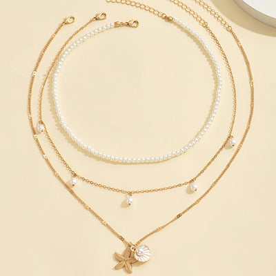 אלינור | שרשרת בסגנון חוף עם תליון צדף וכוכב ים בעיצוב יוקרתי